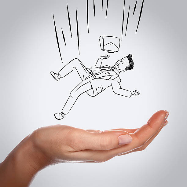 Businessman falling down on hand stock photo