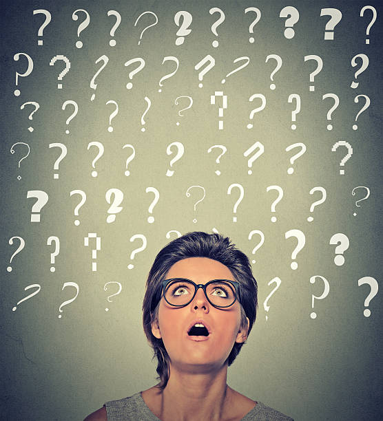 istock surprised woman with glasses looking up on many question marks 492356508