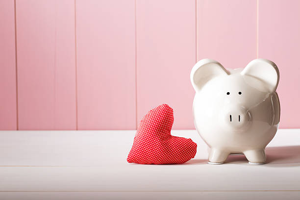 istock Piggy bank with red heart pillow 492357546