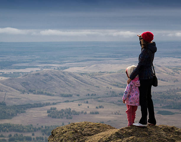 istock Woman and Child Standing on a Mountain 492359644