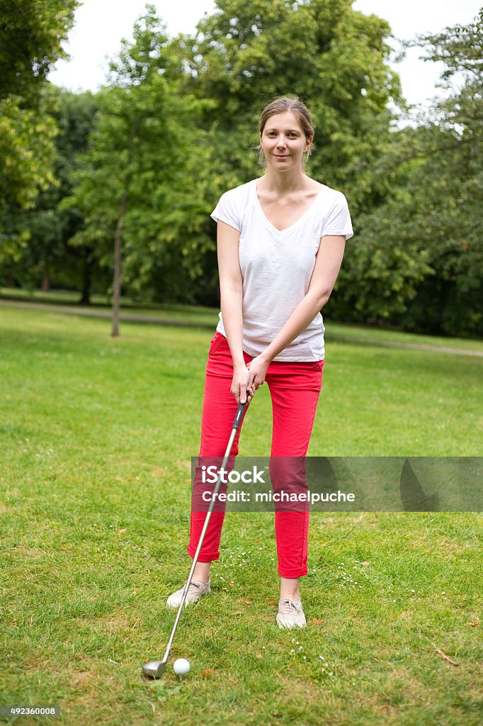 golfer young woman teeing off on the golf course 2015 Stock Photo