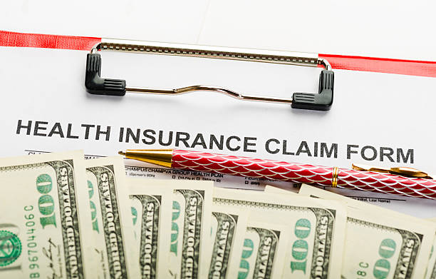 istock Health insurance application form with banknote 492360654