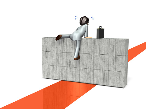 A businessman struggles in his attempt to push a large square concrete block towards a round hole.