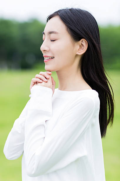 istock pretty girl in prayer 492362494