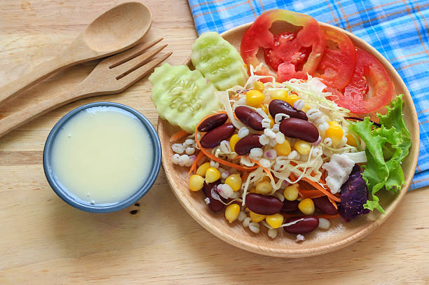 istock Healthy salad with fresh vegetables on wood background 492362738