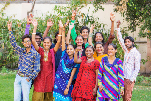 Excited group of young Indian people with their hands in the air