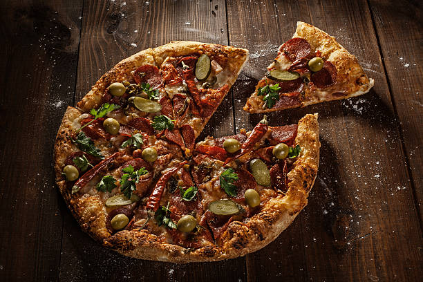 istock delicious italian pizza with slice served on wooden table 492362958