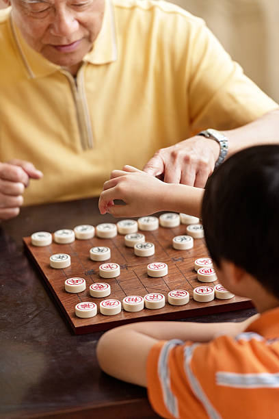 istock Grandfather and grandson playing Xiangqi (chinese chess) 492363085