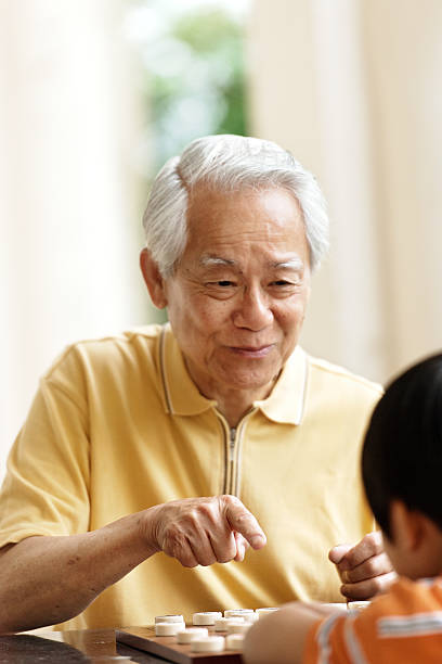 istock Grandfather and grandson playing Xiangqi (chinese chess) 492363087