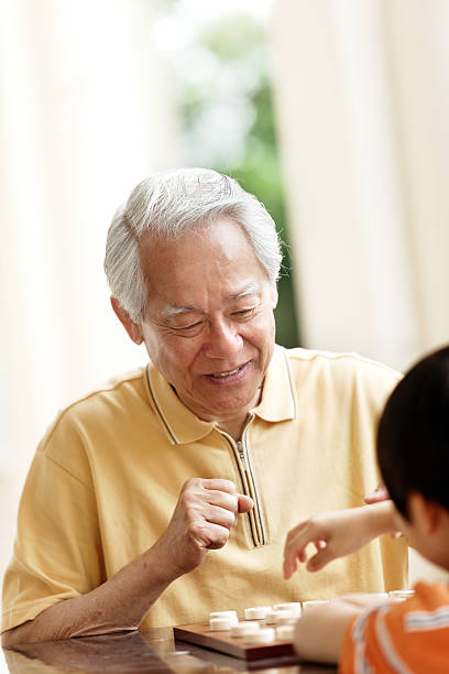 istock Grandfather and grandson playing Xiangqi (chinese chess) 492363089