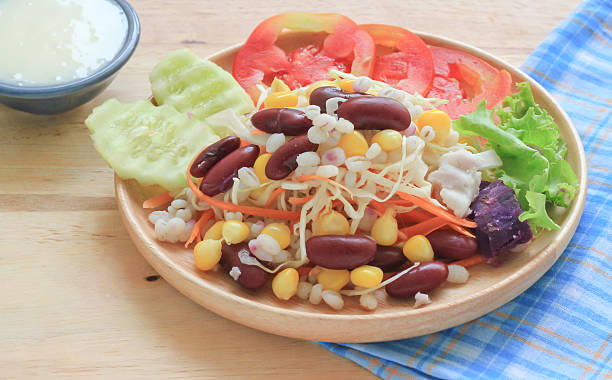 istock Healthy salad with fresh vegetables on wood background 492363106