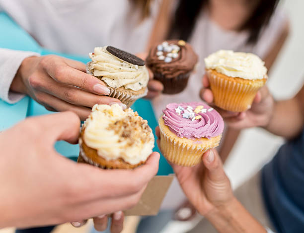 istock Group of friends eating cupcakes 492364036