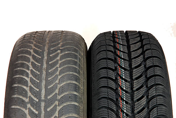 old and new winter car tires stock photo