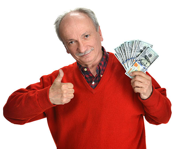 istock Lucky old man holding dollar bills on a white background 492364511