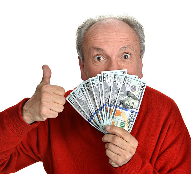 istock Lucky old man holding dollar bills on a white background 492364515