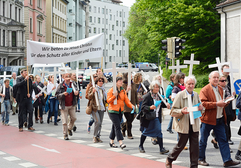 Munich, Germany –  May 10, 2014:  Anti-Abortion Demonstration with participants carrying Christian Crosses and banners.  Hundreds protested peacefully in Munich. 