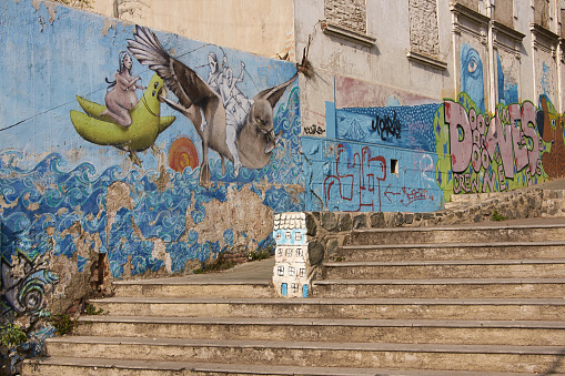 Valparaiso, Chile - May 13, 2014: Colourful murals decorating a cafe in the UNESCO world heritage city of Valparaiso in Chile. Valparaiso is renowned for the number and quality of tghe murals decorating streets and buildings around the city.