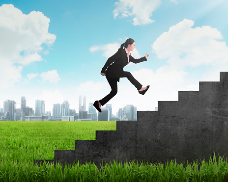 Business person jump to the highest stair. Business achievement concept