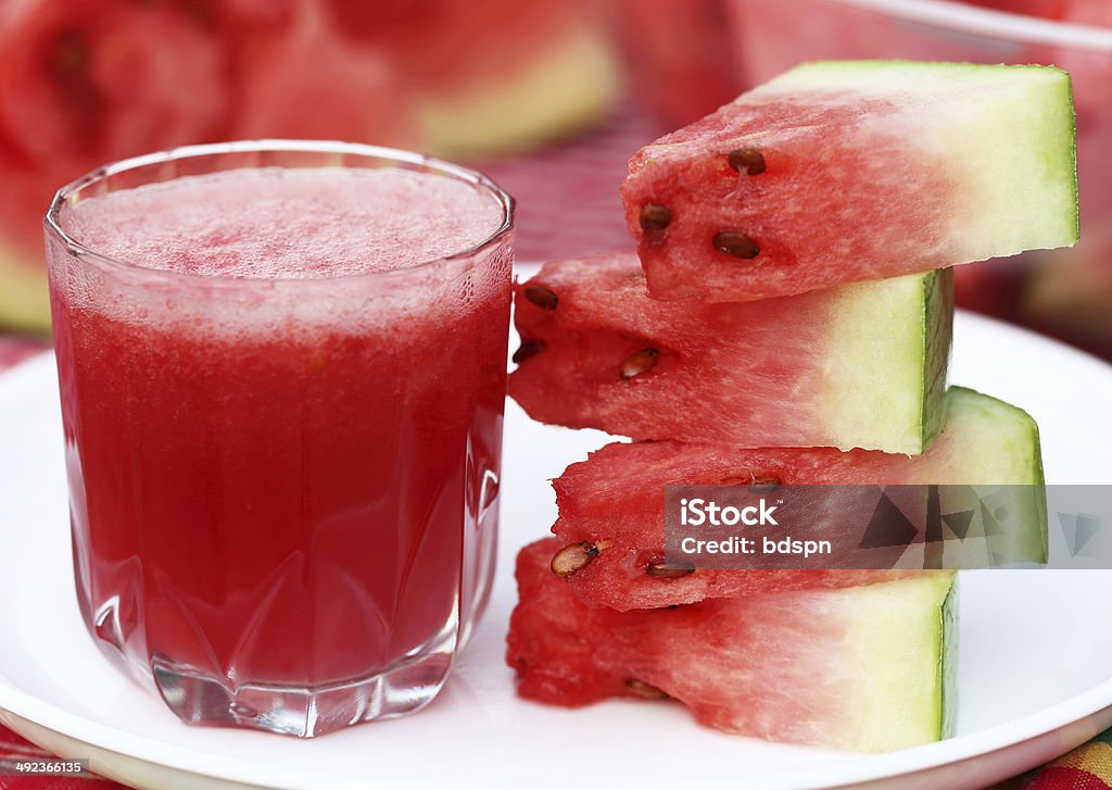Watermelon juice with sliced fruit on white plate Watermelon juice with sliced fruit Chopped Food Stock Photo