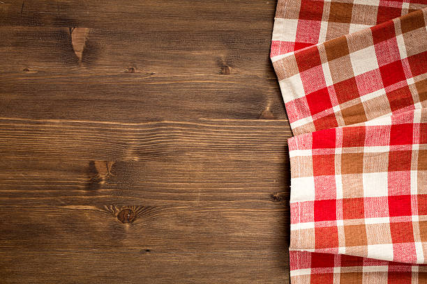 Checkered napkin at right side  of wooden background