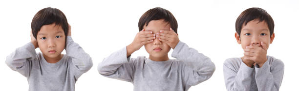 portrait of boy closing the eyes mouth and ears. portrait of boy standing closing the eyes mouth and ears. Isolated on white background man closing ears photos stock pictures, royalty-free photos & images