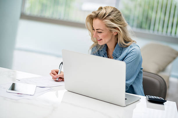 istock Woman paying her bills online on a laptop 492369732