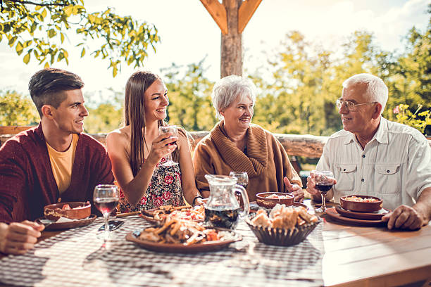 istock Smiling family having lunch in the restaurant and communicating. 492369870