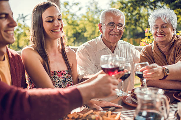 istock Smiling family toasting with wine in a restaurant. 492369930