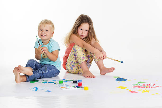 istock Two children are drawing pictures by paints 492370598