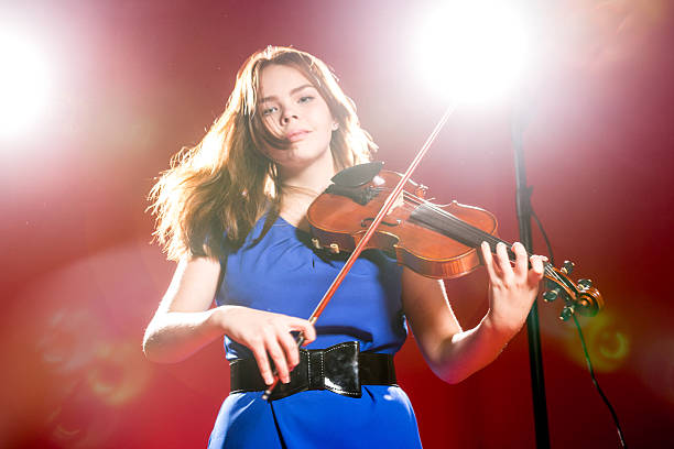 istock Young Violinist In The Spotlight 492370808