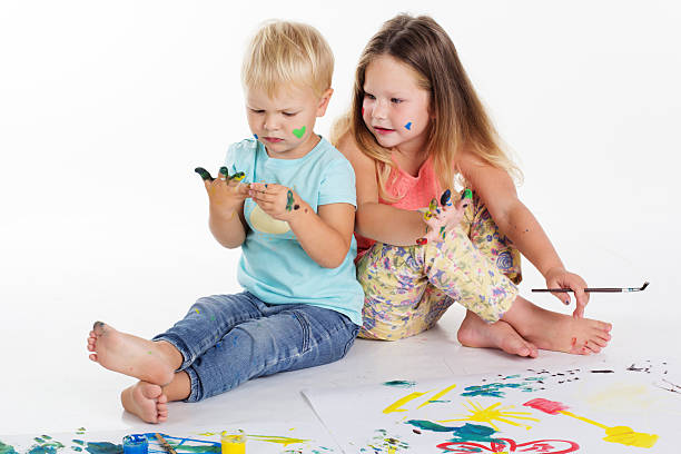 istock Two babies are drawing by aquarelle paints 492370822