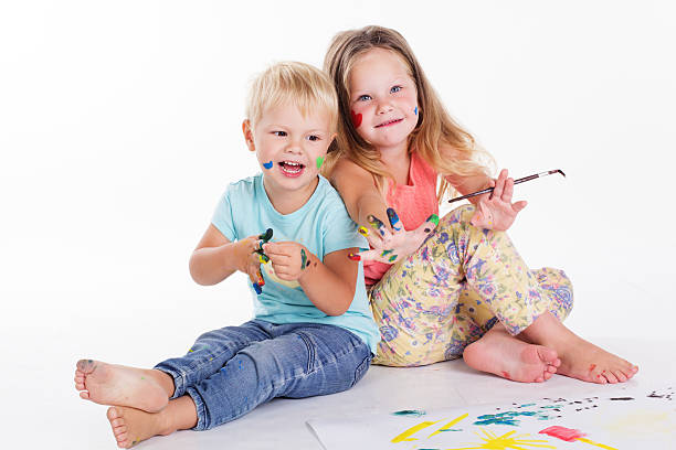 istock Two babies are drawing by aquarelle paints 492370864