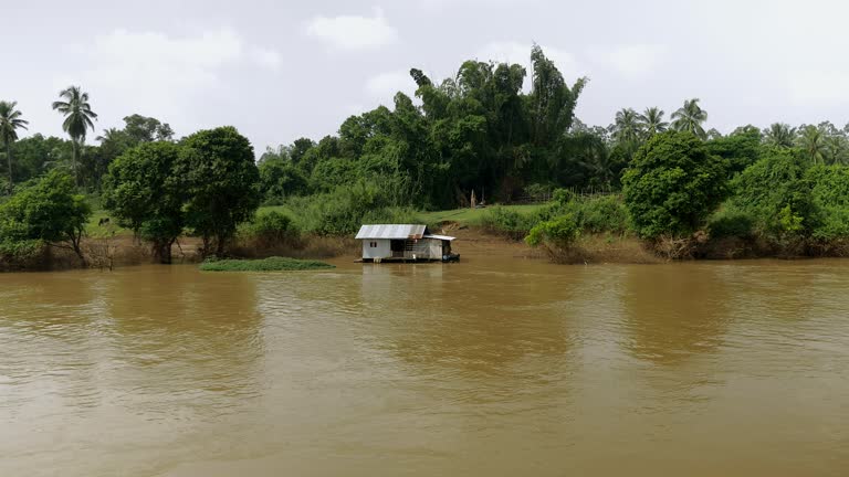 Houseboat on the river next to the riverbank