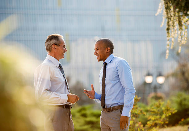istock Smiling businessmen communicating outdoors. 492383716