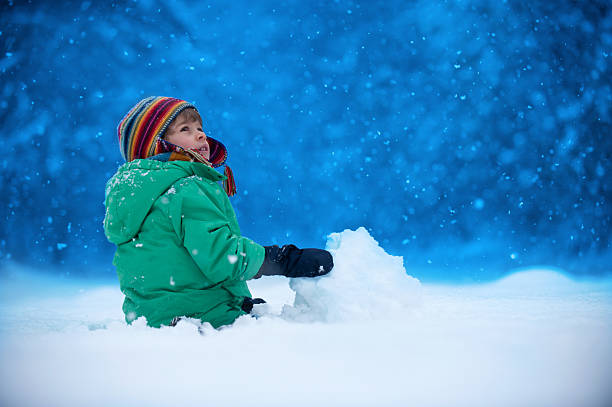 istock Little boy playing in snow 492384402