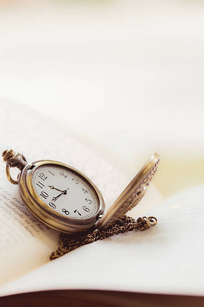istock Vintage pocket watch on old books. 492385002