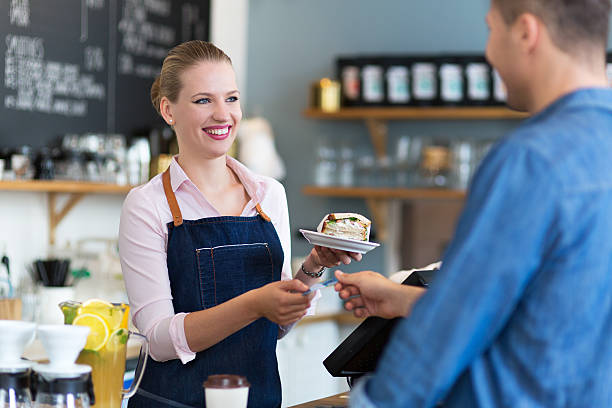istock Barista serving customer in coffee shop 492385682