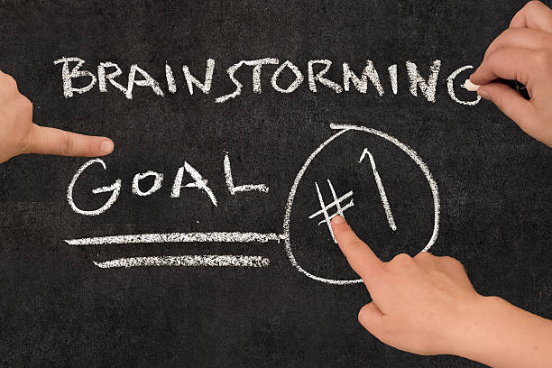 istock Blackboard on business meeting with three people brainstorming and writing 492387346