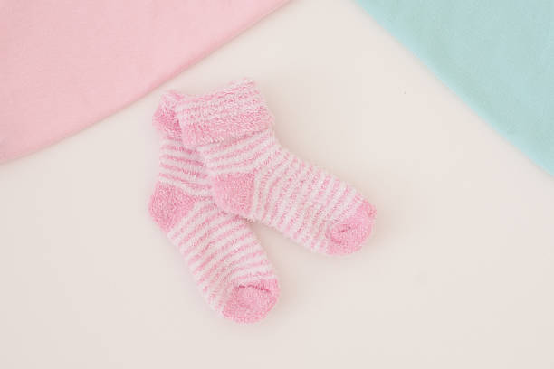 istock little baby socks on white background - studio shot 492388976