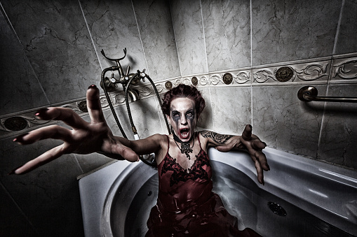 Halloween theme.Scary girl in bath.