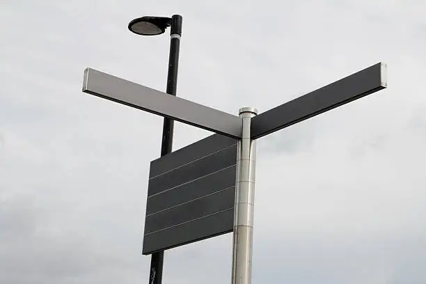 Streetsigns with a street light on a grey cloudy day, add your own texts