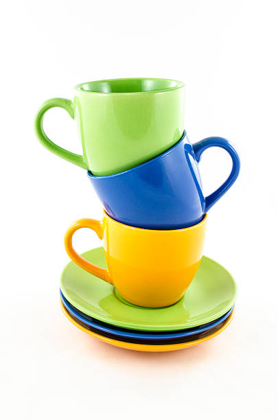 istock Mix of tea and coffee colorful cups isolated on white 492396018