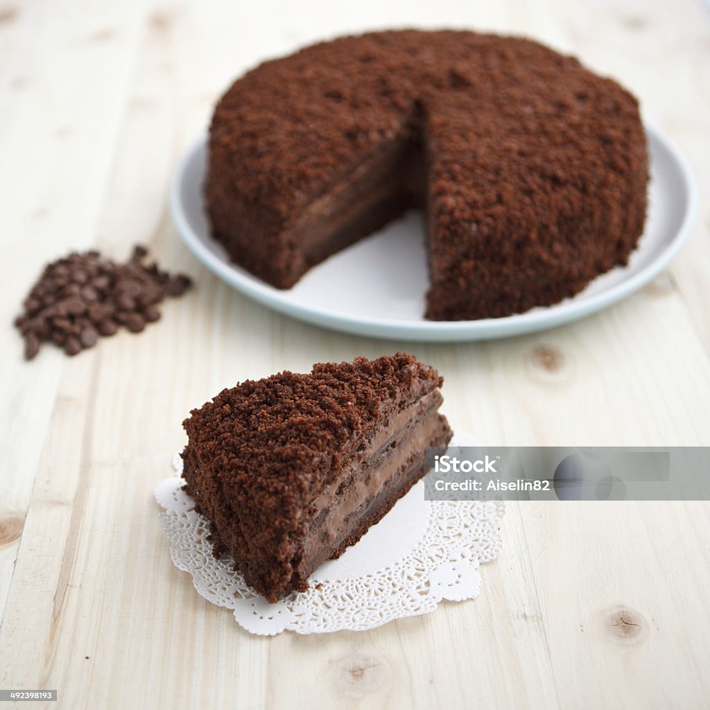 Homemade chocolate blackout cake with a cut piece Homemade chocolate blackout cake with a cut piece on a light wooden table Blackout Stock Photo