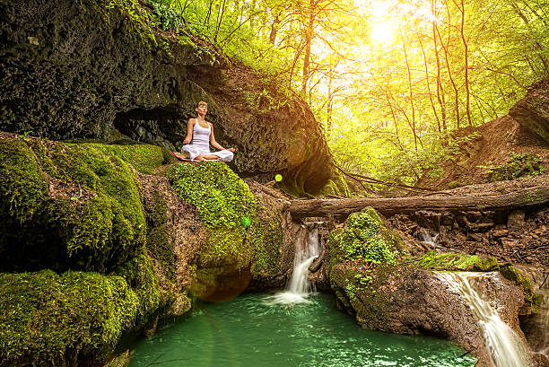 istock Relaxation in forest at the Waterfall. Ardha Padmasana pose. 492398767