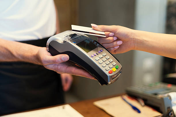 istock Close up of customer paying by credit card 492399193