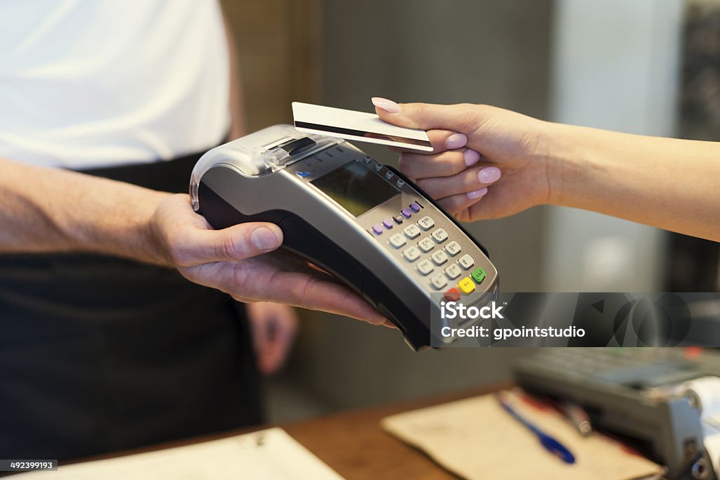 Close up of customer paying by credit card Machinery Stock Photo