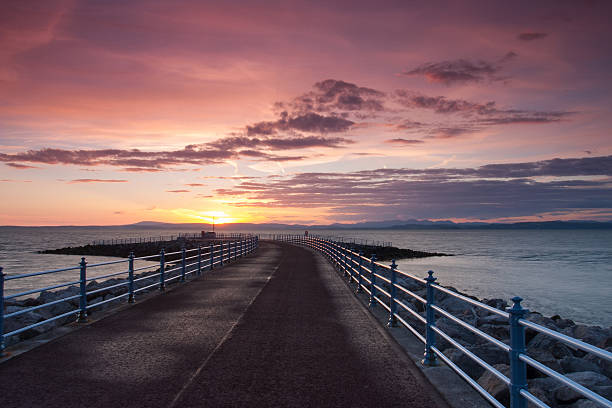 Sunset on the pier in Morecambe Sunset on the pier in Morecambe, Great Britain morecombe bay photos stock pictures, royalty-free photos & images