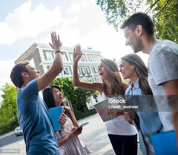 Students Giving A Highfive Stock Photo - Download Image Now - Educational Exam, Celebration, Success