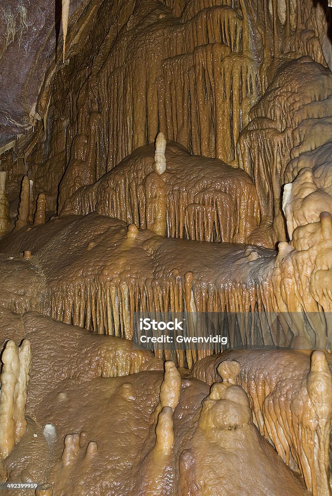 cave walls of a cave covered with ochre stalagmites Calcite Stock Photo