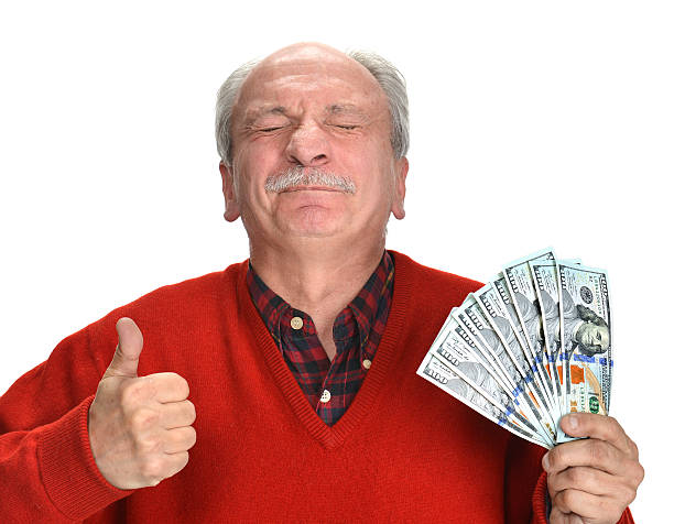 istock Lucky old man holding dollar bills 492402235